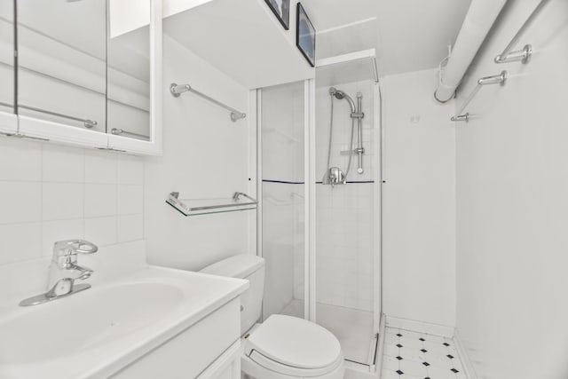 bathroom featuring vanity, backsplash, toilet, and walk in shower