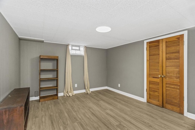 unfurnished bedroom with hardwood / wood-style floors and a closet