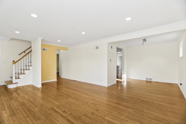 unfurnished living room with crown molding and wood-type flooring