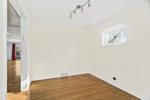 unfurnished room with hardwood / wood-style flooring and ornamental molding