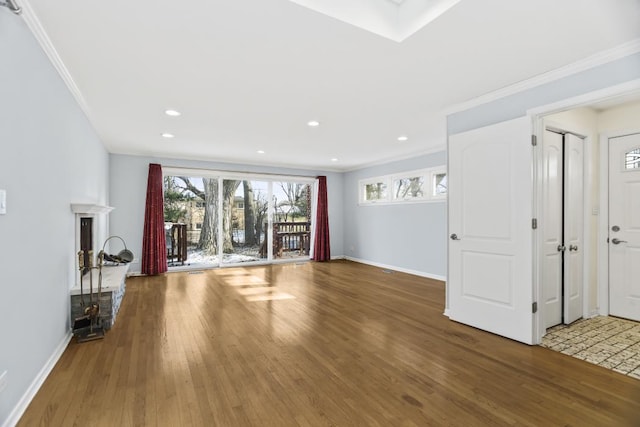 unfurnished living room featuring hardwood / wood-style flooring and crown molding