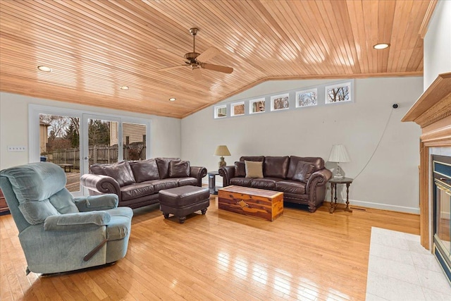 living room featuring lofted ceiling, light hardwood / wood-style floors, french doors, and a healthy amount of sunlight