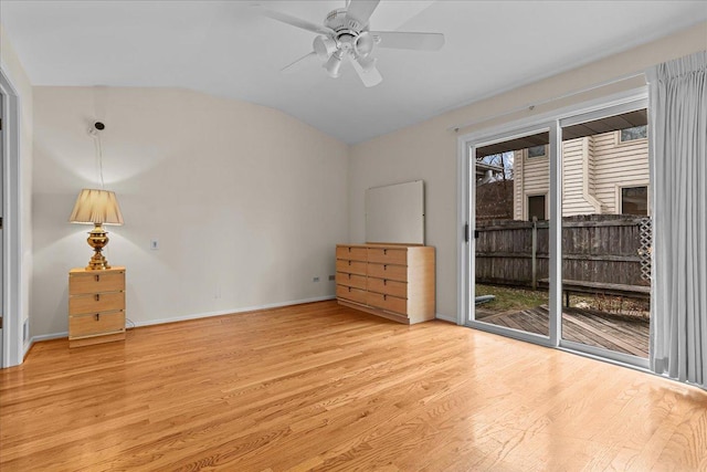 interior space with ceiling fan, access to outside, vaulted ceiling, and light wood-type flooring