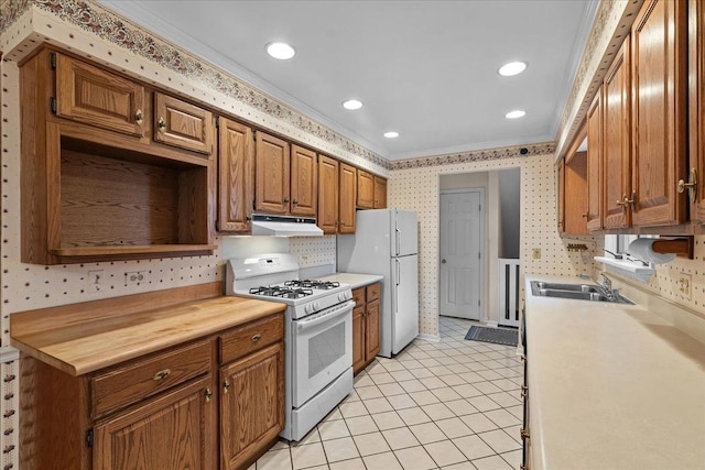 kitchen with crown molding, sink, light tile patterned floors, and white appliances