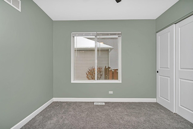 unfurnished bedroom featuring carpet flooring and a closet