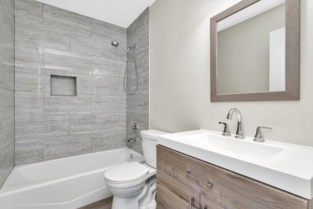 full bathroom with tiled shower / bath combo, vanity, and toilet