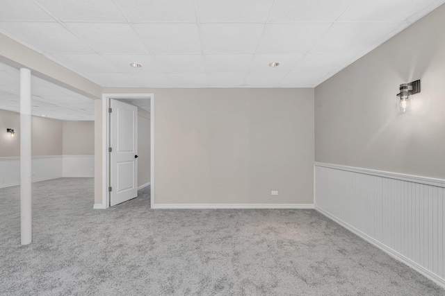 basement with carpet floors and a drop ceiling