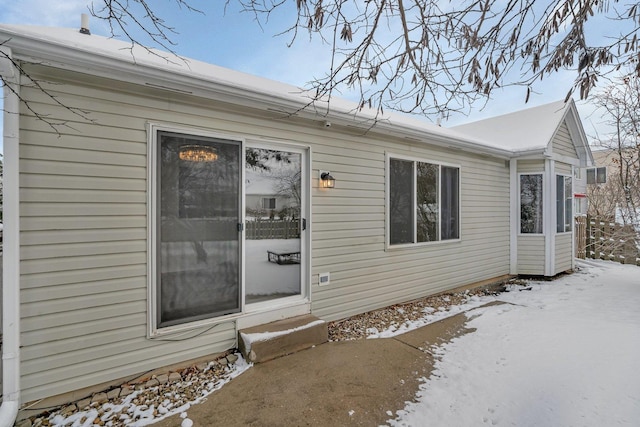 view of snow covered property entrance