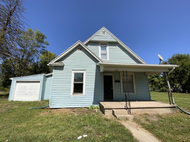 view of front facade featuring a porch, a garage, and a front yard