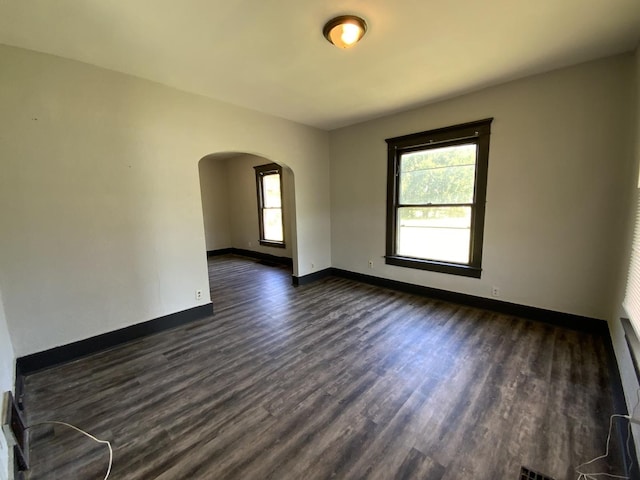 empty room featuring dark hardwood / wood-style flooring