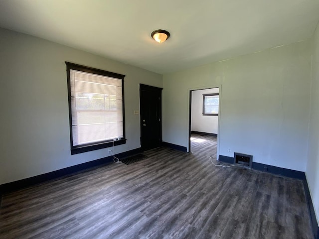 spare room featuring dark hardwood / wood-style flooring