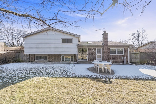 rear view of house with a patio and a lawn