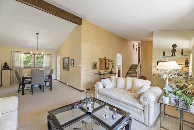 carpeted living room with a chandelier and vaulted ceiling with beams