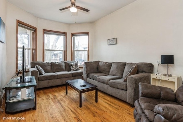 living room with a healthy amount of sunlight, ceiling fan, and light hardwood / wood-style flooring