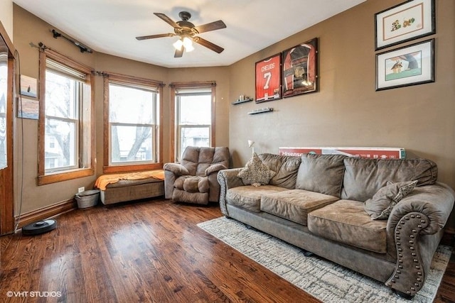 living room featuring wood-type flooring and ceiling fan