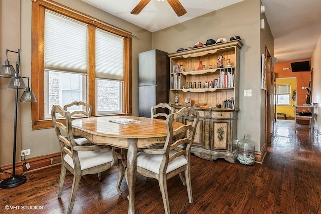 dining area featuring dark wood-type flooring and ceiling fan