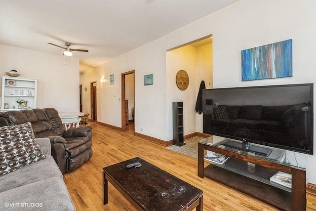 living room with hardwood / wood-style flooring and ceiling fan