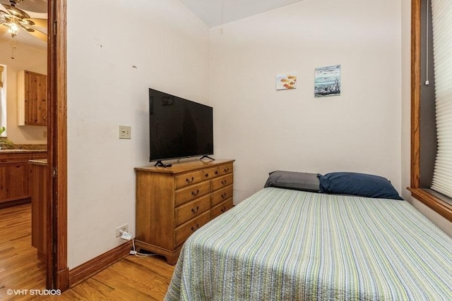 bedroom featuring lofted ceiling and light hardwood / wood-style floors