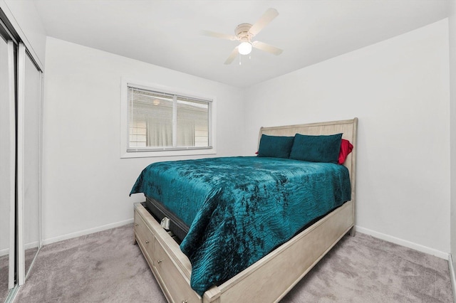 bedroom featuring light carpet, a closet, and ceiling fan