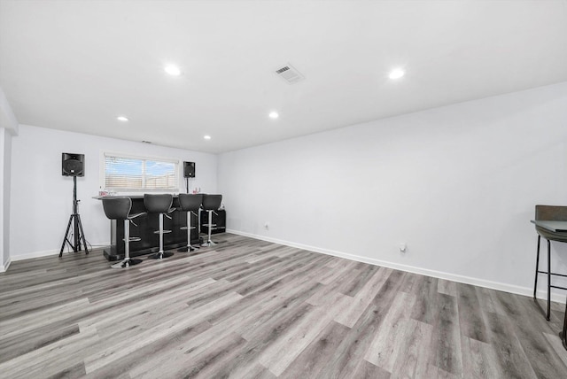 bar featuring light hardwood / wood-style flooring