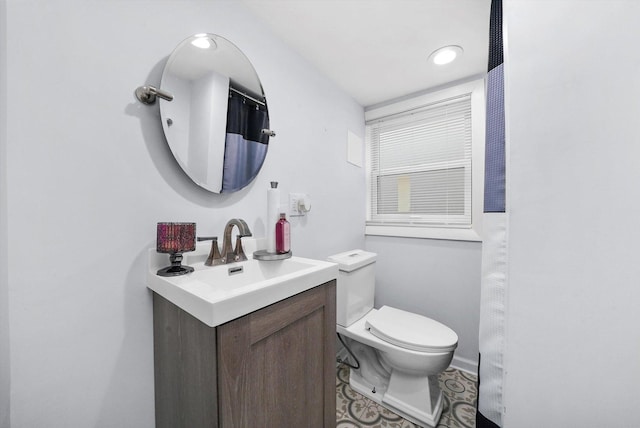 bathroom featuring vanity and toilet