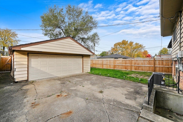 garage featuring a yard and central air condition unit