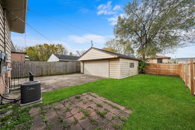 view of yard featuring an outbuilding, a garage, a patio, and cooling unit