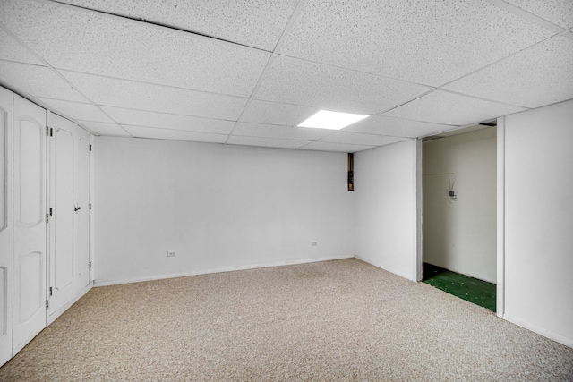 basement with carpet floors and a paneled ceiling