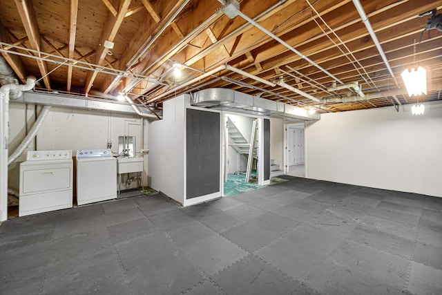 basement featuring sink and washing machine and dryer