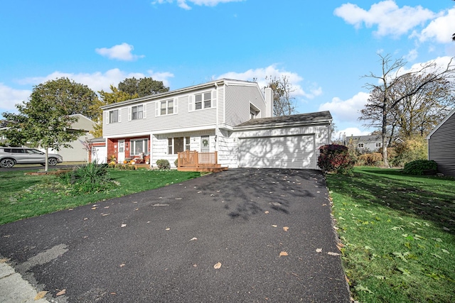 view of front of home featuring a garage and a front lawn