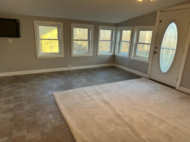 foyer entrance featuring vaulted ceiling