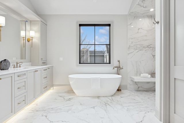 bathroom featuring vanity and a bath