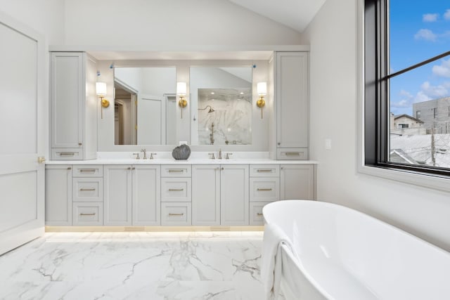 bathroom with vanity, vaulted ceiling, and separate shower and tub