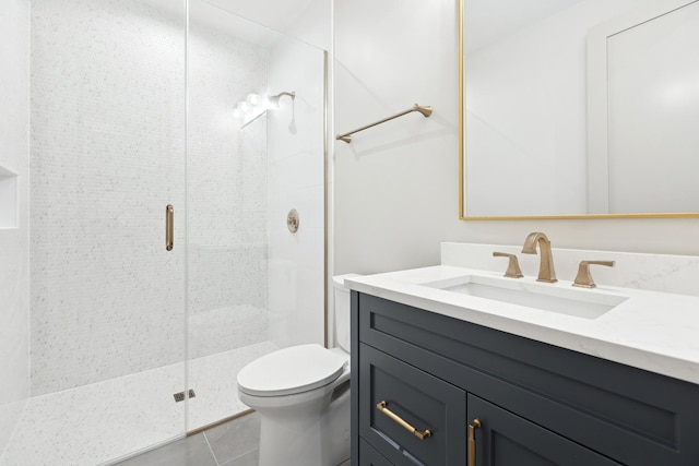 bathroom featuring vanity, a shower with shower door, tile patterned floors, and toilet