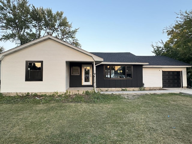 ranch-style home featuring a garage and a front yard