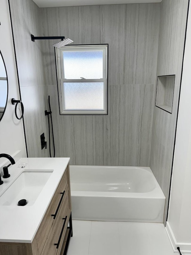 bathroom with vanity, tiled shower / bath combo, and tile patterned floors