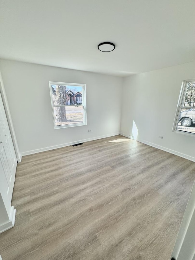 unfurnished room with light hardwood / wood-style floors