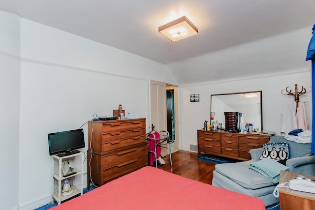 bedroom featuring lofted ceiling and dark hardwood / wood-style floors