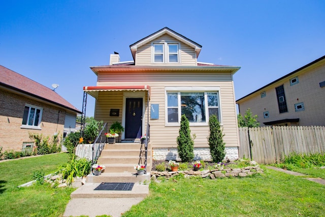 bungalow-style home with a front lawn