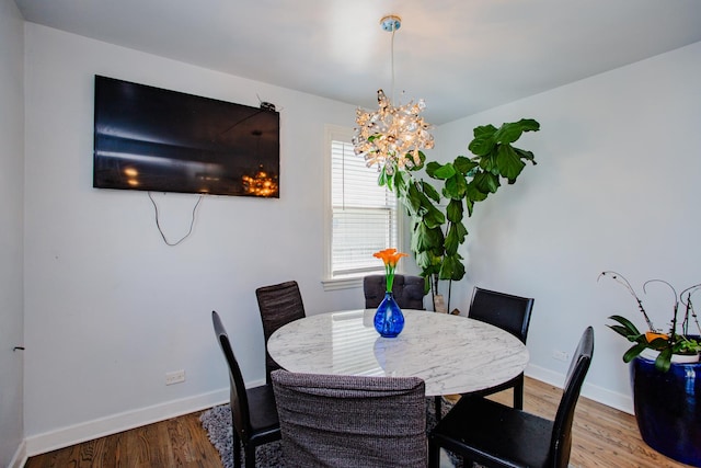 dining space featuring an inviting chandelier and light wood-type flooring