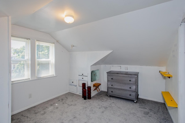 bonus room featuring lofted ceiling and light colored carpet