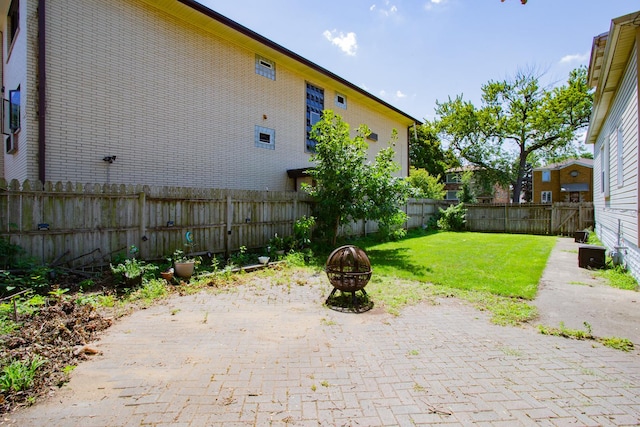 view of yard with a fire pit