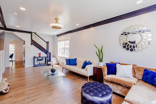 living room featuring hardwood / wood-style floors and crown molding