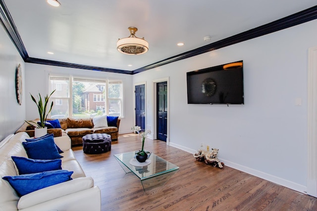 living room featuring hardwood / wood-style flooring and crown molding