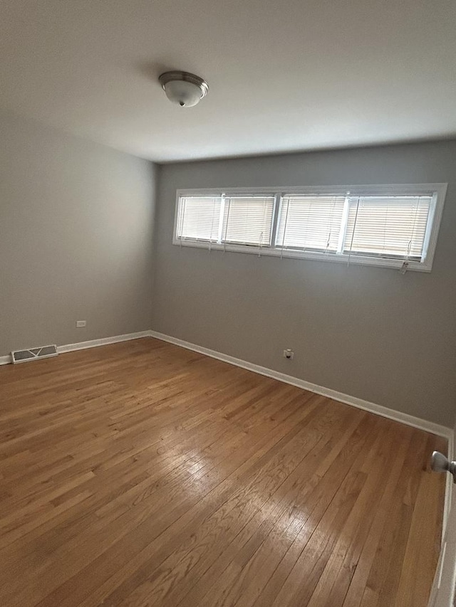 spare room featuring hardwood / wood-style floors