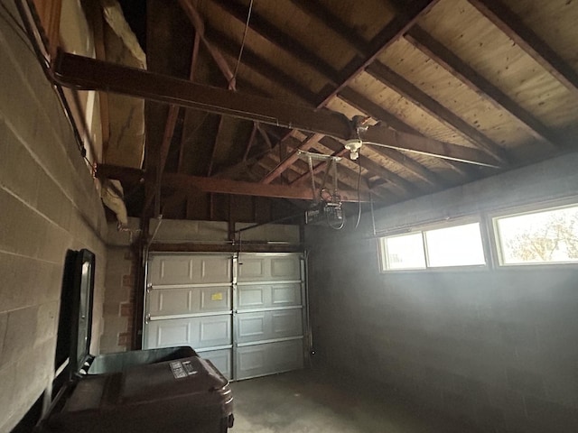 garage featuring a garage door opener and wood ceiling