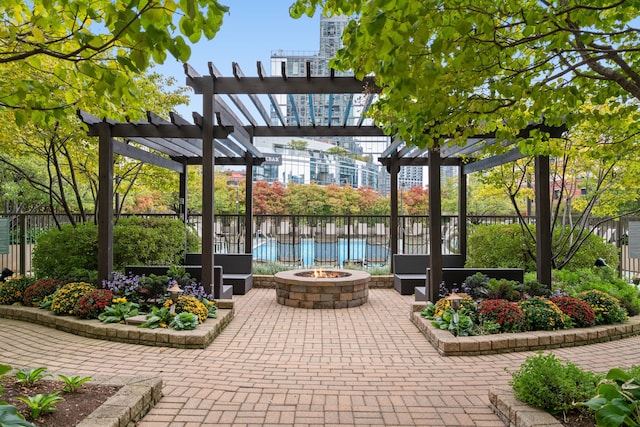 view of patio featuring a pool, an outdoor fire pit, and a pergola