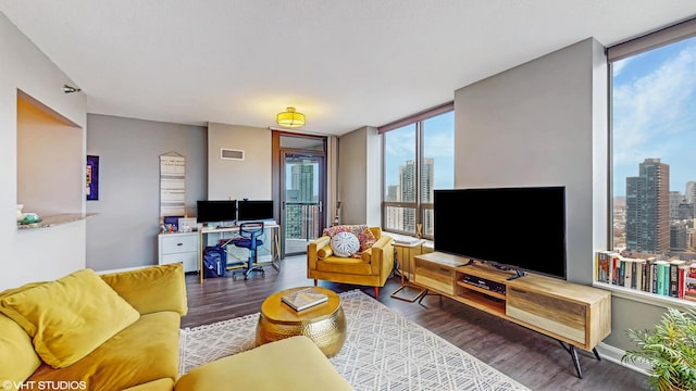 living room with hardwood / wood-style flooring and a wall of windows