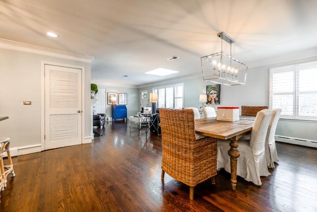 dining room with a baseboard heating unit, crown molding, a healthy amount of sunlight, and dark hardwood / wood-style floors