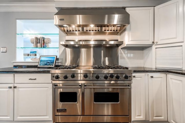 kitchen featuring range hood, white cabinetry, backsplash, double oven range, and crown molding